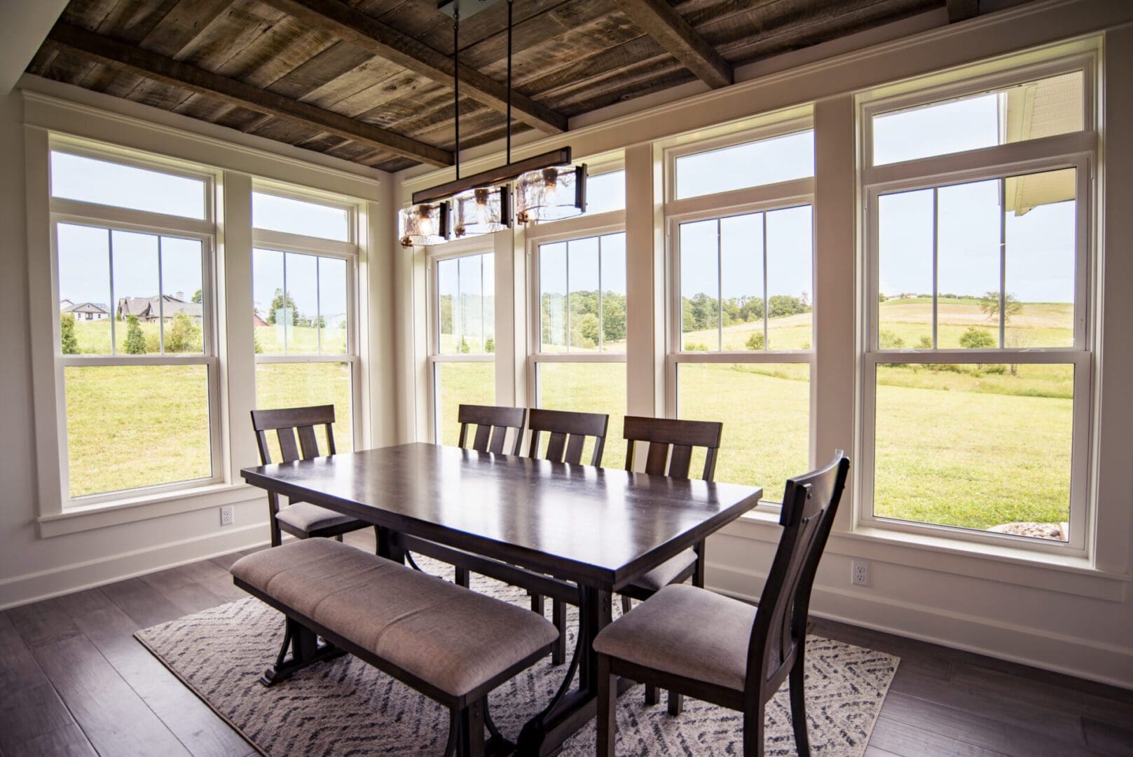 A dining room table with chairs and benches